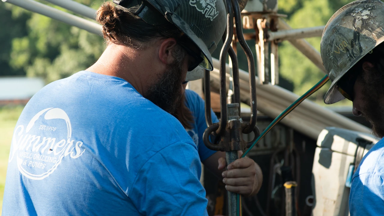 A Summers Well Drilling crew installing a well pump